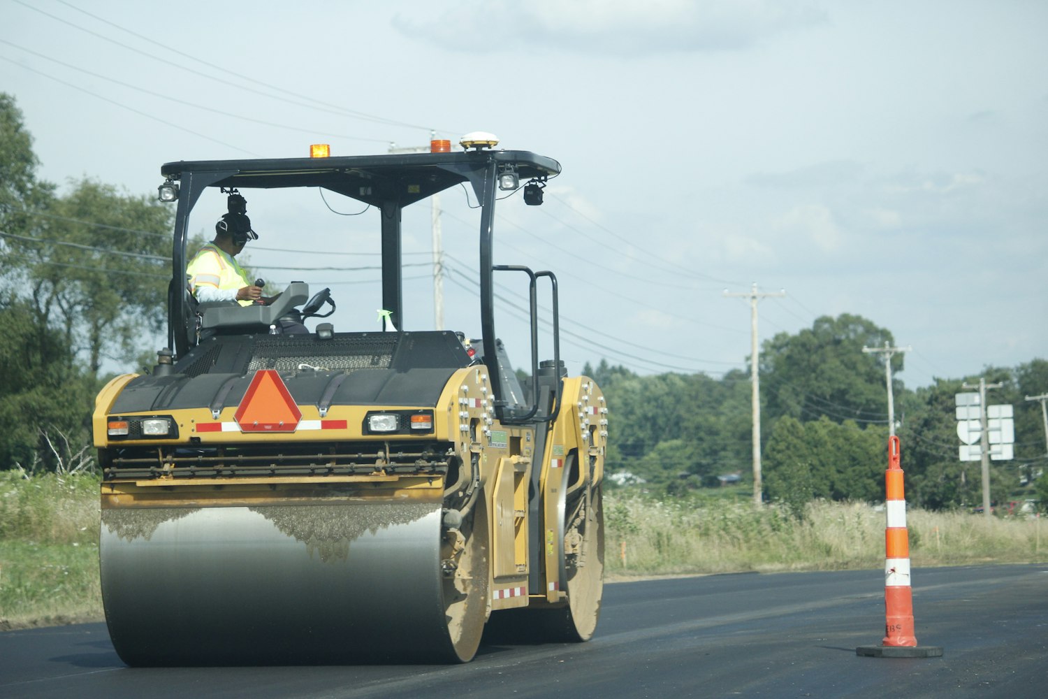 Paving equipment on a road in bright daylight